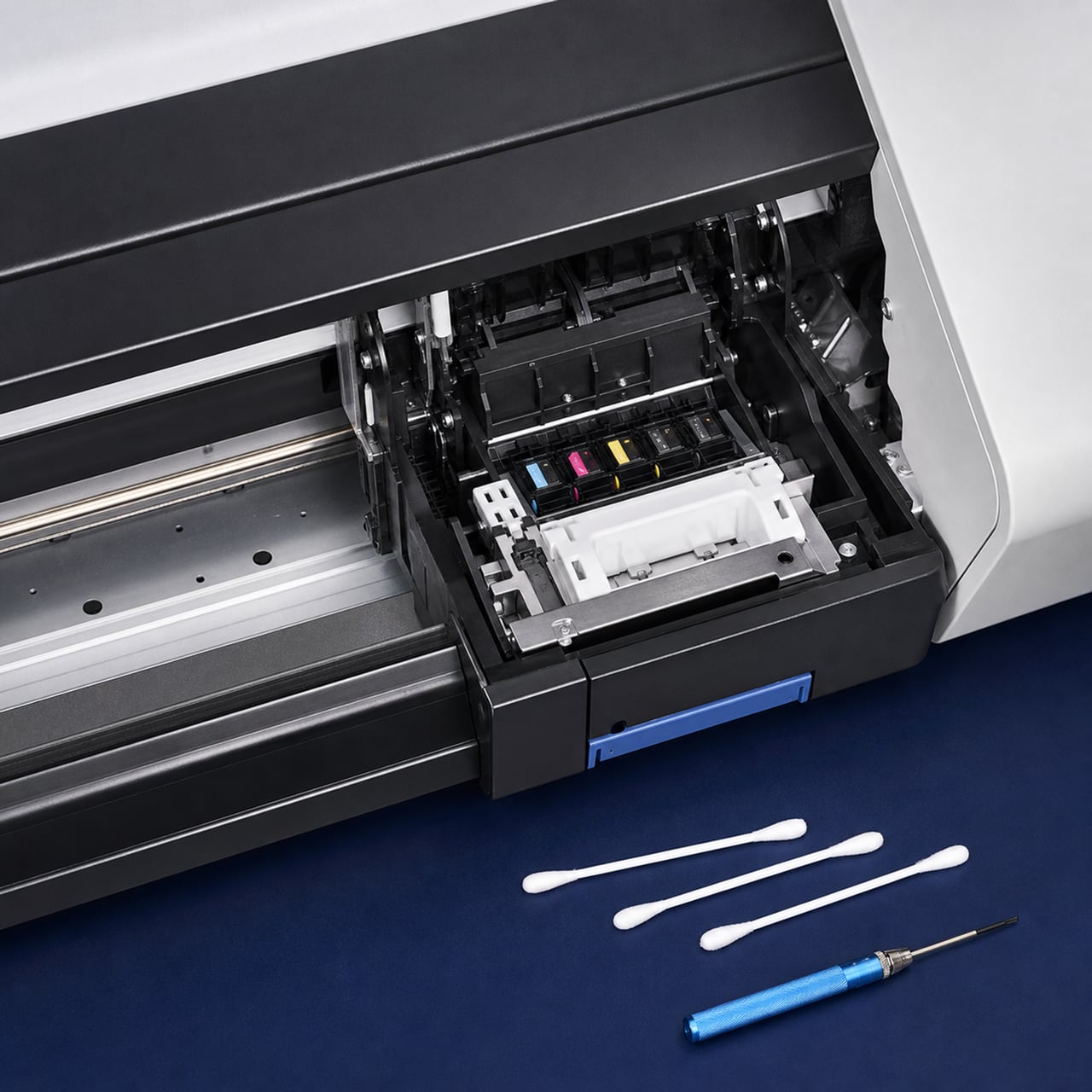 Large-format printer carriage maintenance station with lint-free tools
