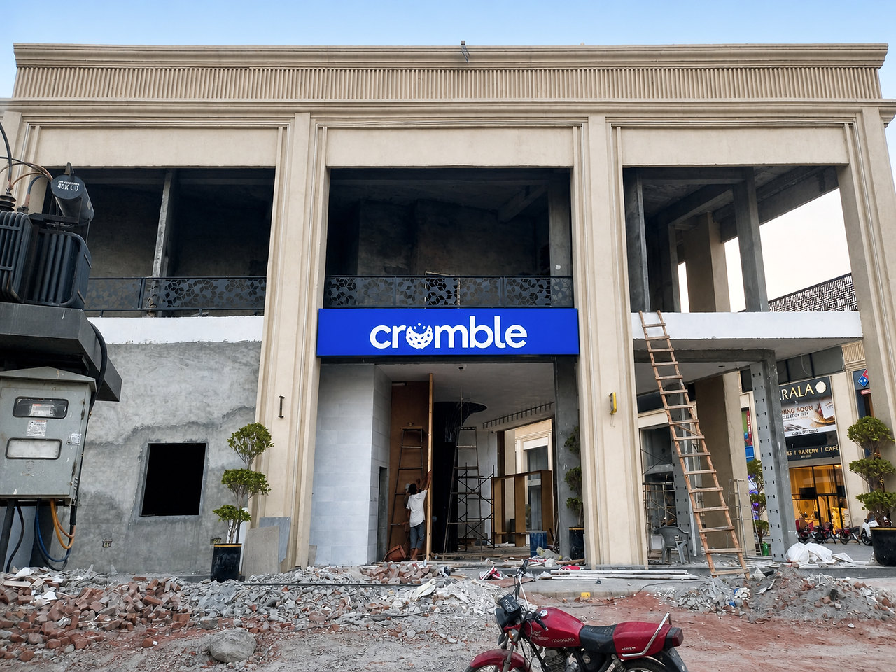 CRUMBLE illuminated signboard centred on a commercial facade during installation