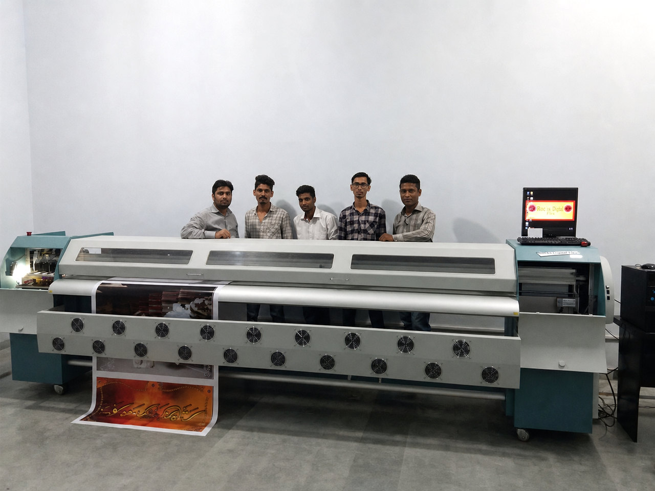 Rocks Digital Flex team members with a large-format printing machine